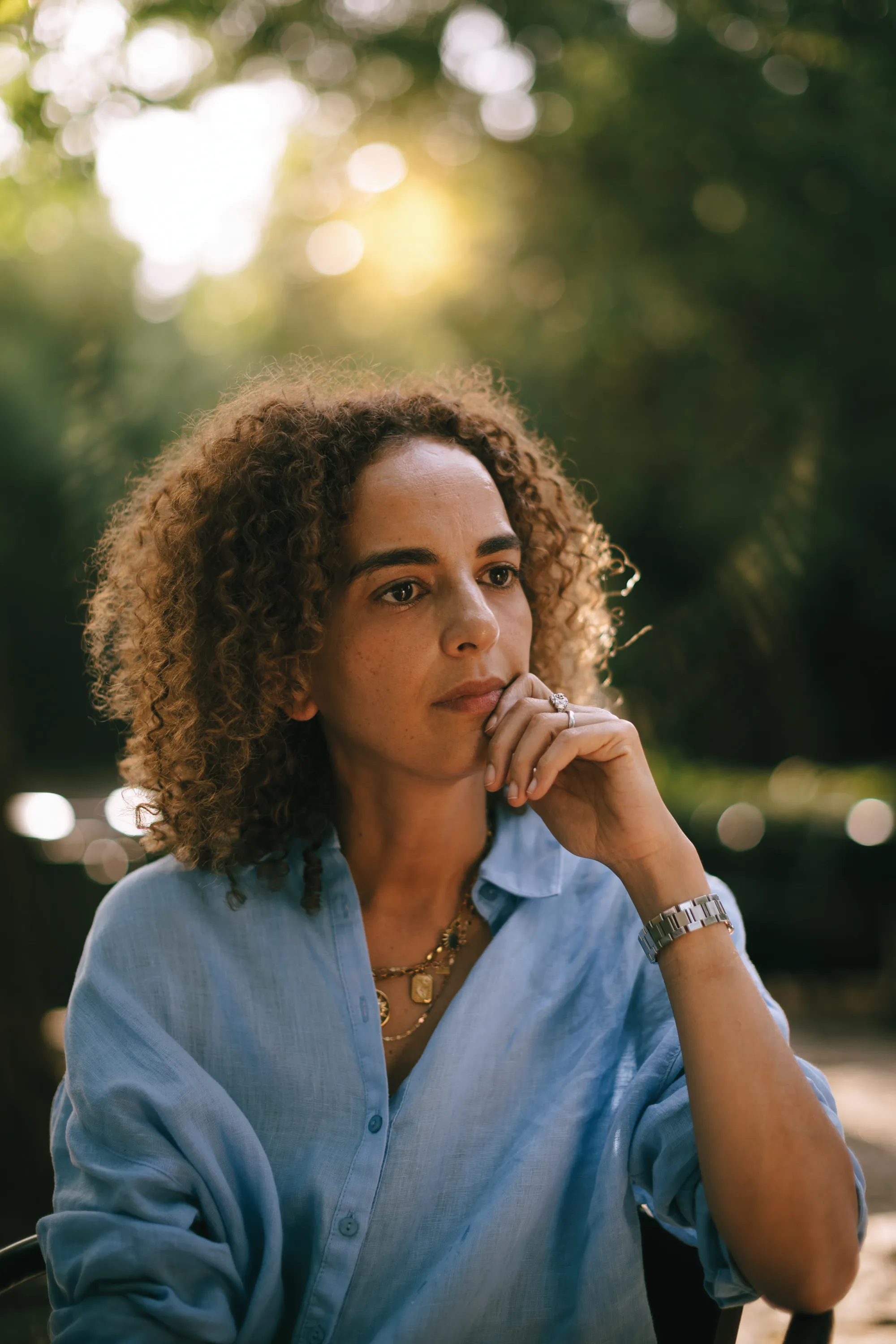 Leila Slimani, portrait in golden light wearing blue shirt