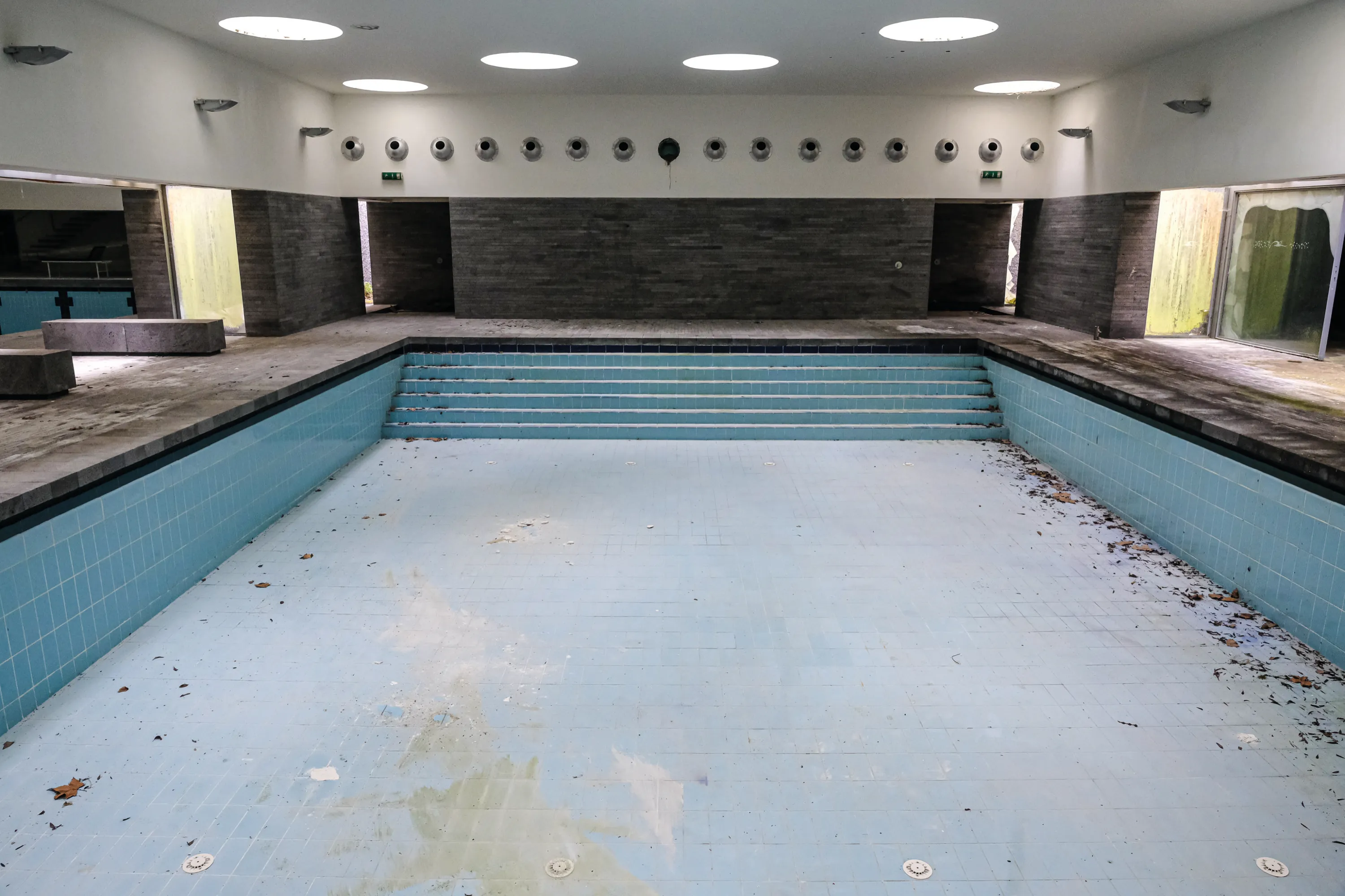 Interior of the abandoned Povoação municipal pool, empty basin and Brutalist architecture