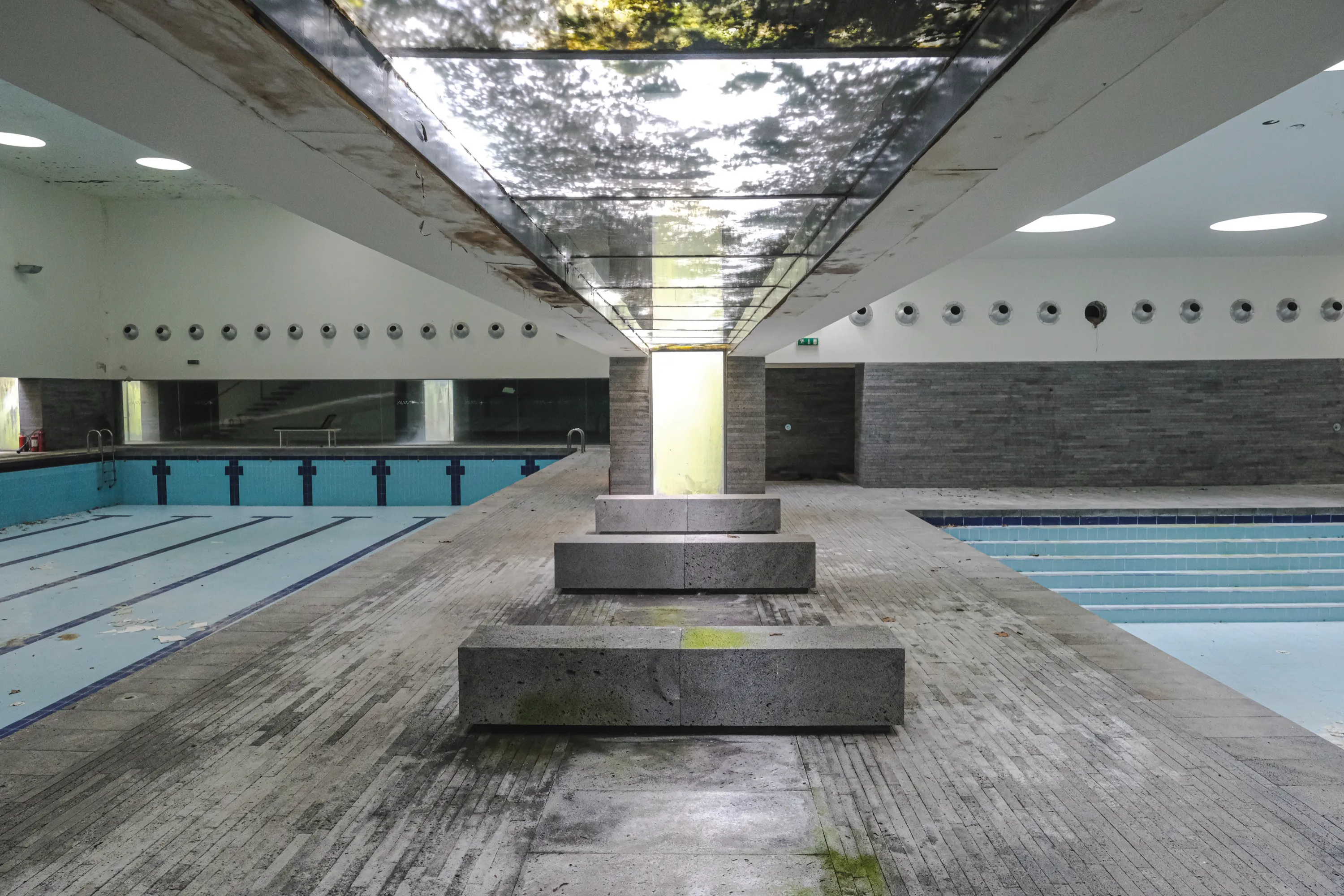 Povoacao municipal swimming pool, abandoned interior with diving platform and lanes